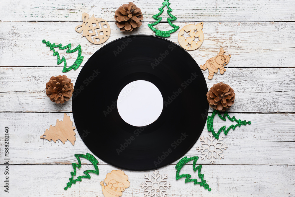 Vinyl disk and Christmas decor on wooden background