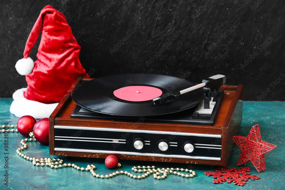 Record player and Christmas decor on table