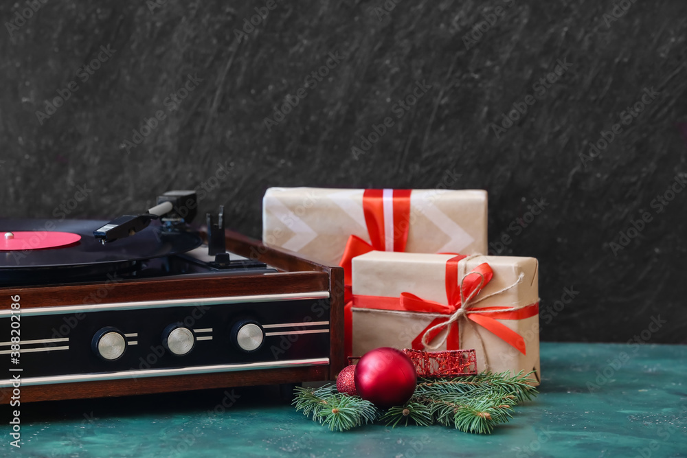 Record player and Christmas decor on table