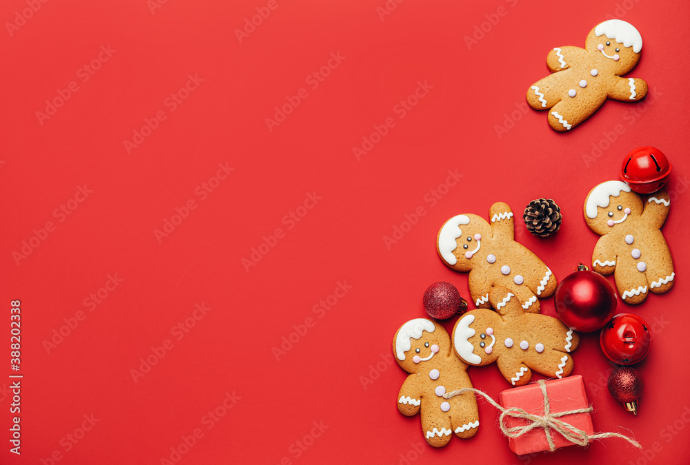 Tasty gingerbread cookies and Christmas decor on color background