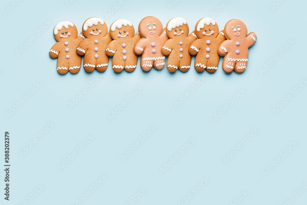 Tasty gingerbread cookies on color background