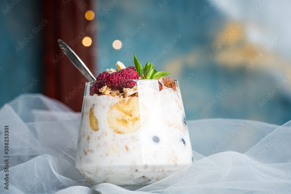 Berry fruit parfait in a glass cup closeup