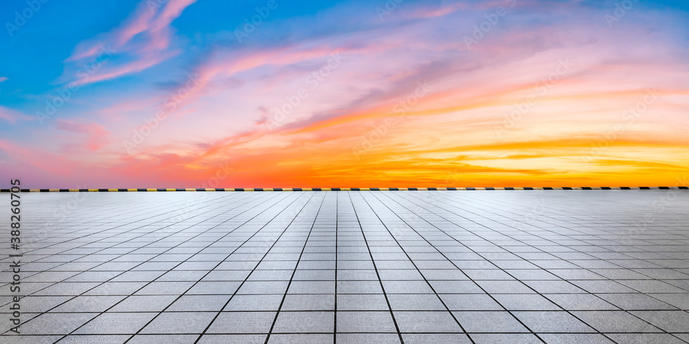 Wide square floor and colorful sky clouds at sunrise.