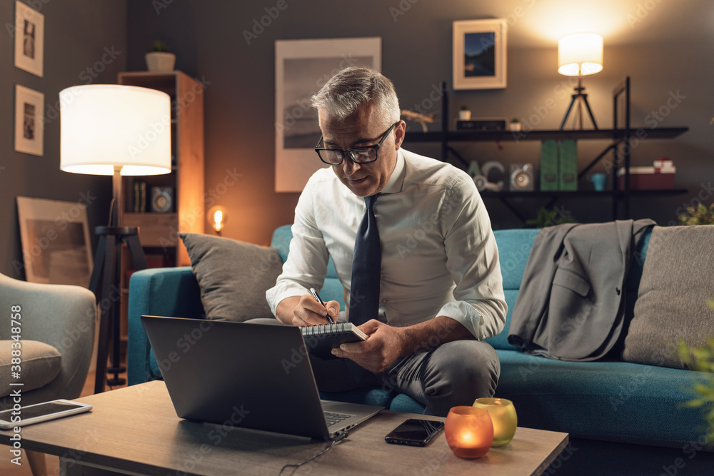 Businessman working from home at night