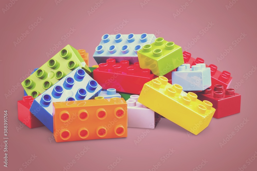 Colorful children building bricks on desk