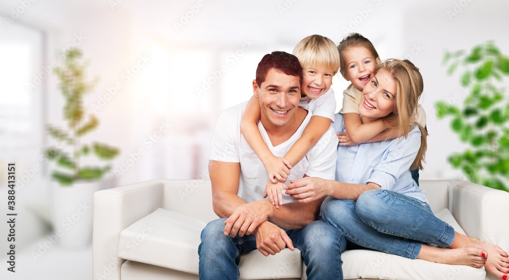 Beautiful smiling lovely family sitting on sofa