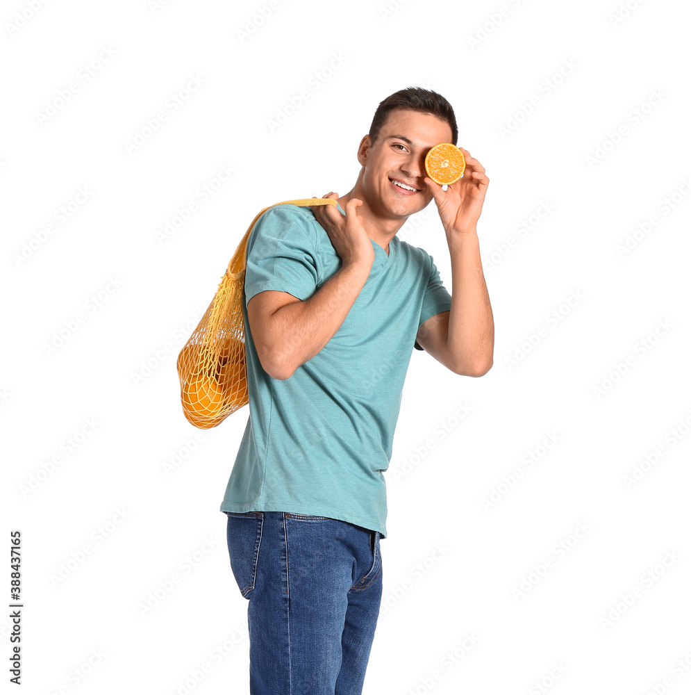 Handsome man with ripe oranges on white background