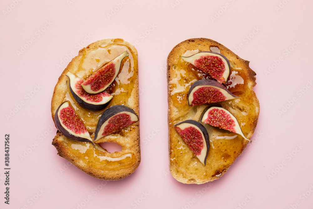 Tasty sandwiches with sweet fig jam on color background