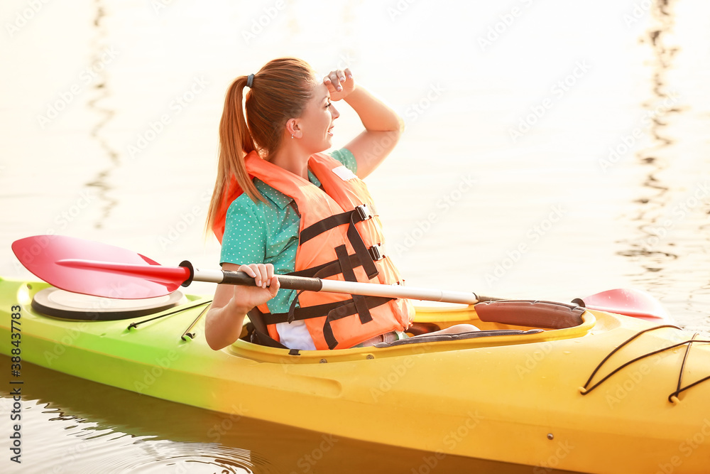 Young woman kayaking in river