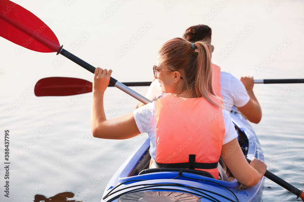 Young couple kayaking in river