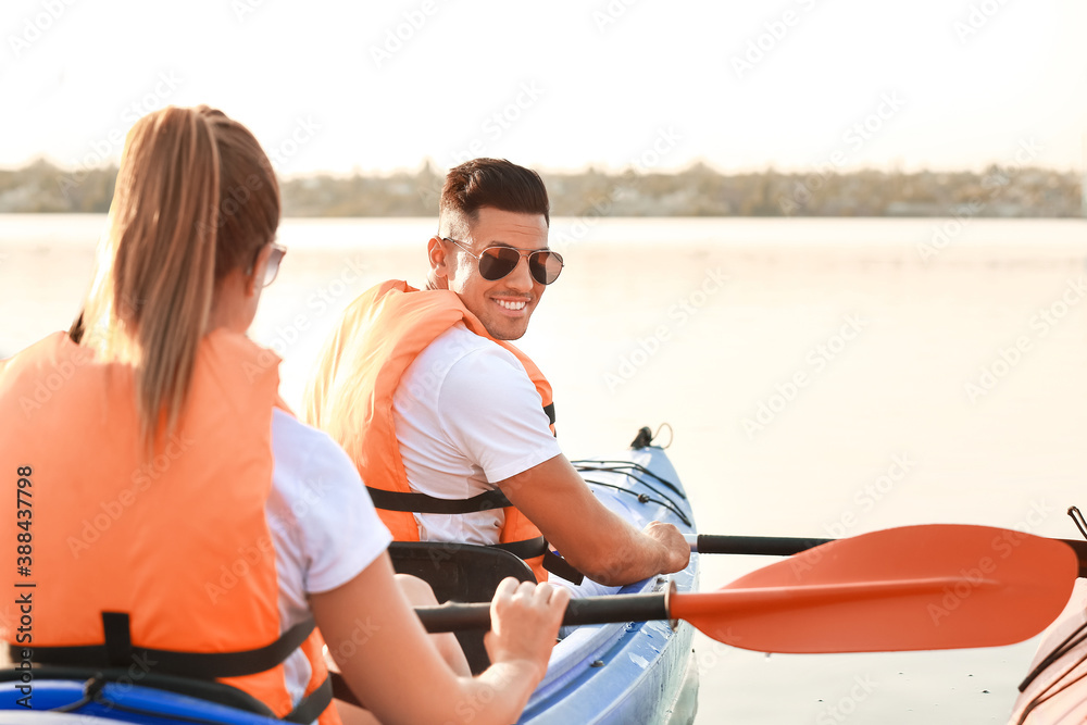 Young couple kayaking in river