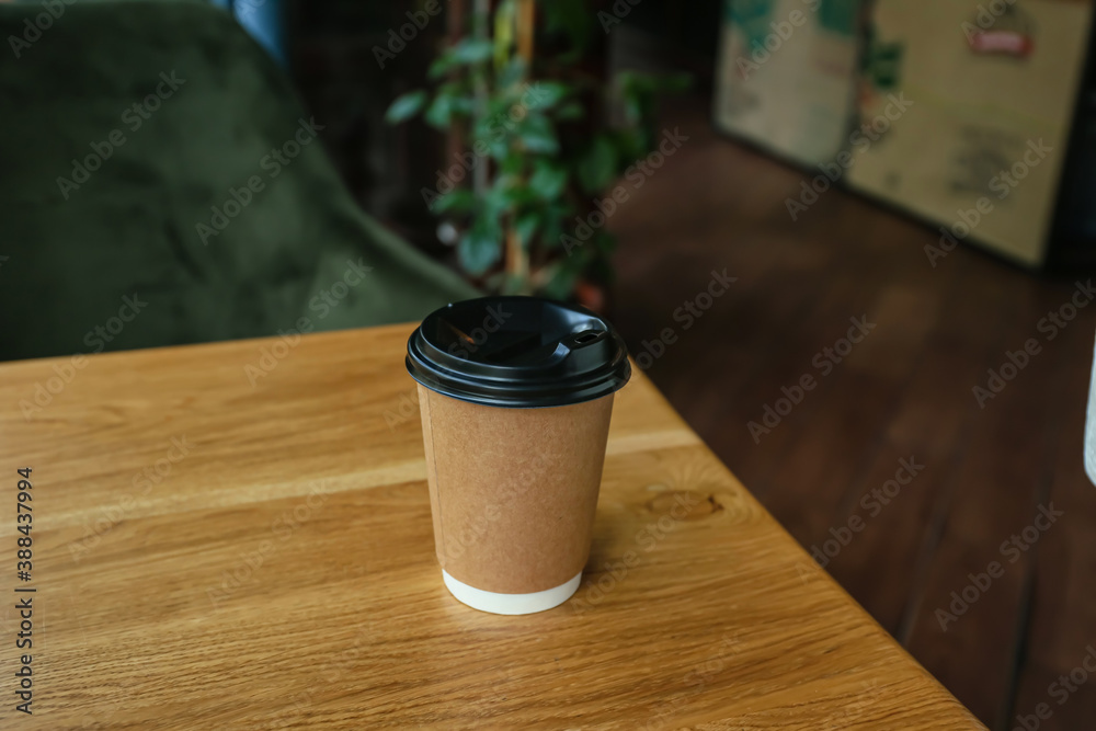 Cup of hot coffee on table in cafe