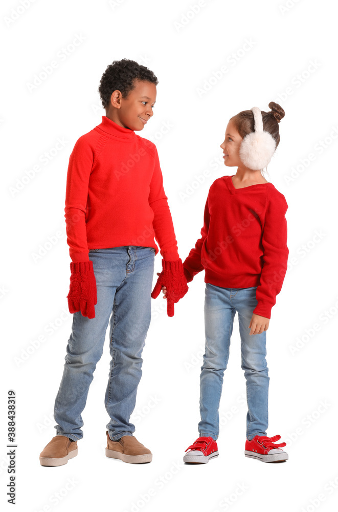 Cute children in winter clothes on white background