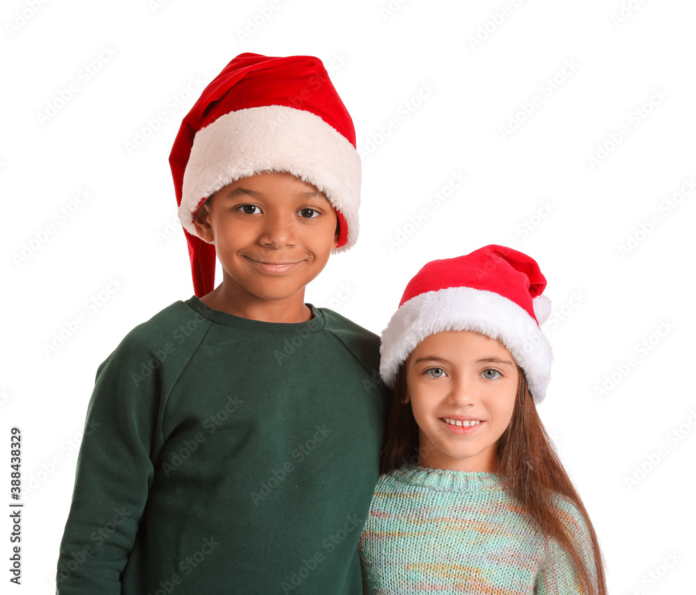 Cute children in winter clothes and Santa hats on white background