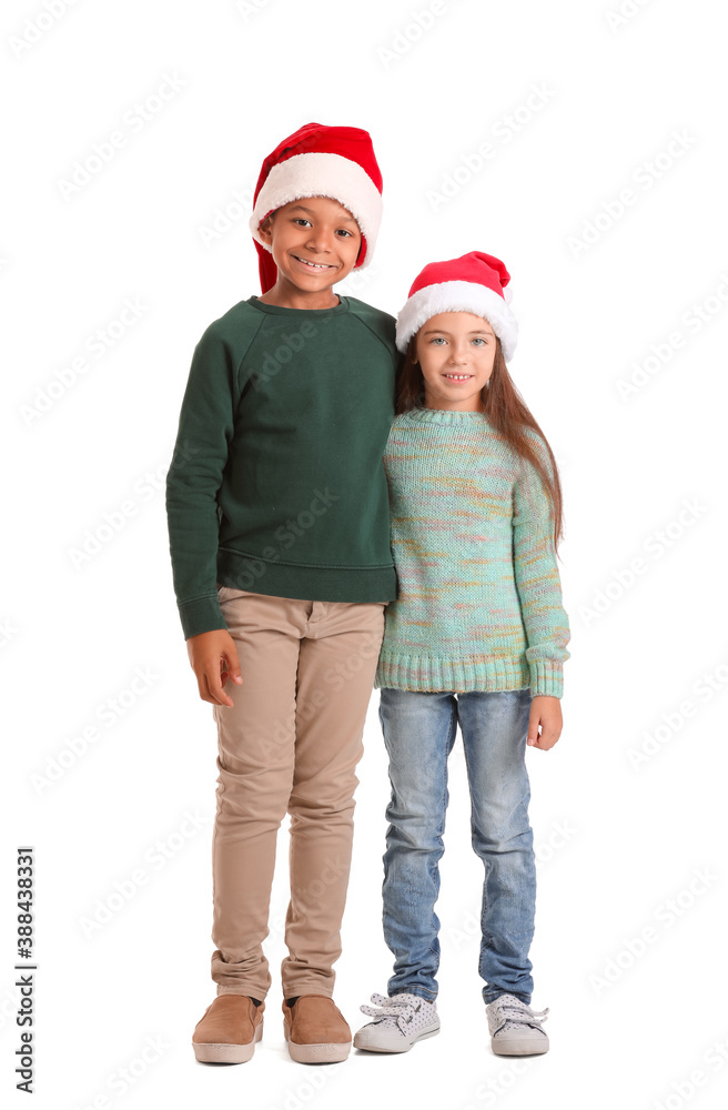 Cute children in winter clothes and Santa hats on white background