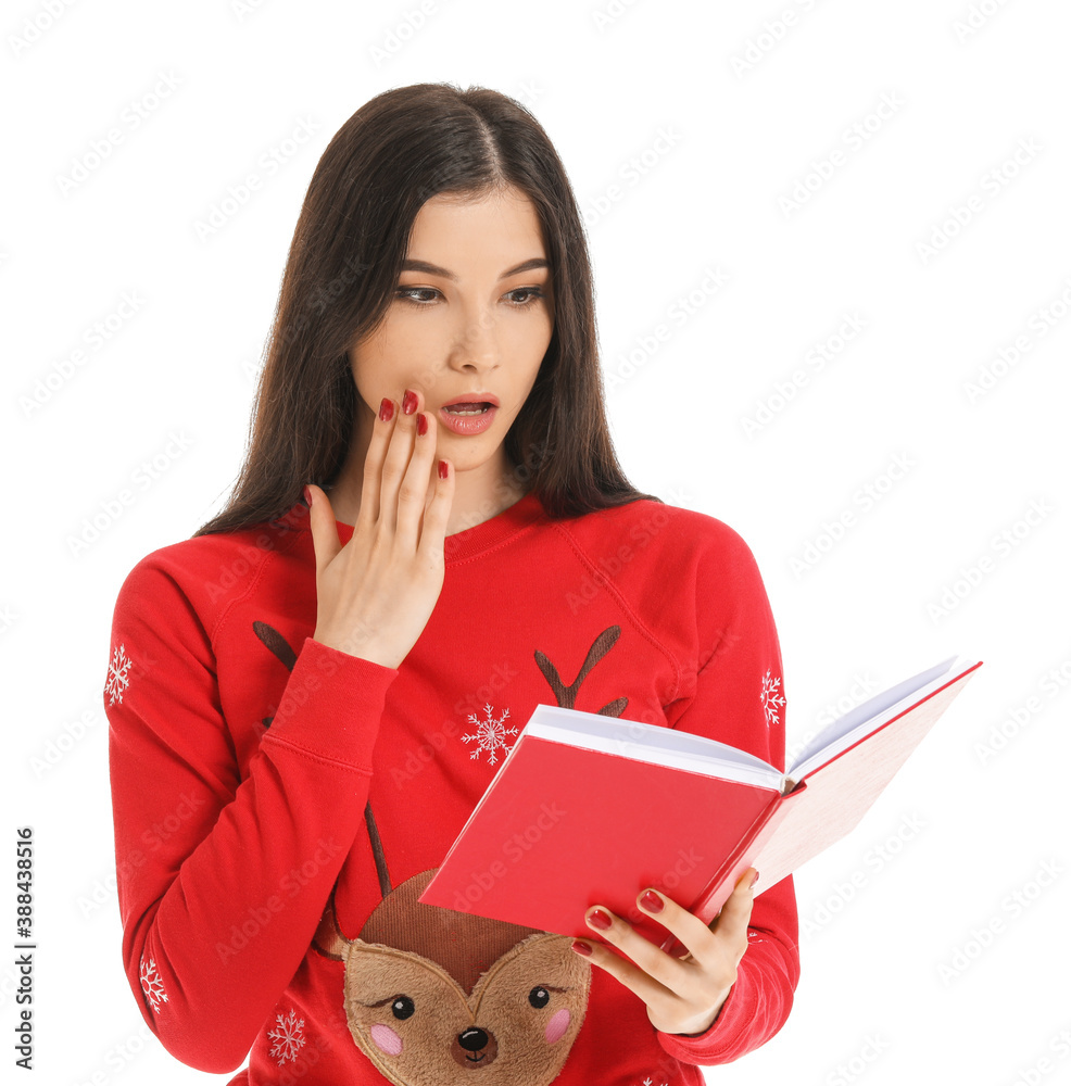 Shocked young woman with book on white background