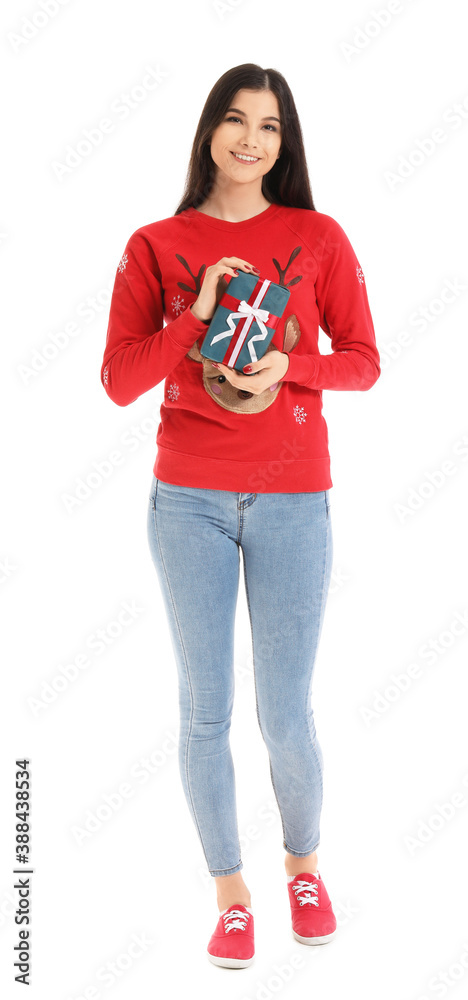 Beautiful young woman with Christmas gift on white background