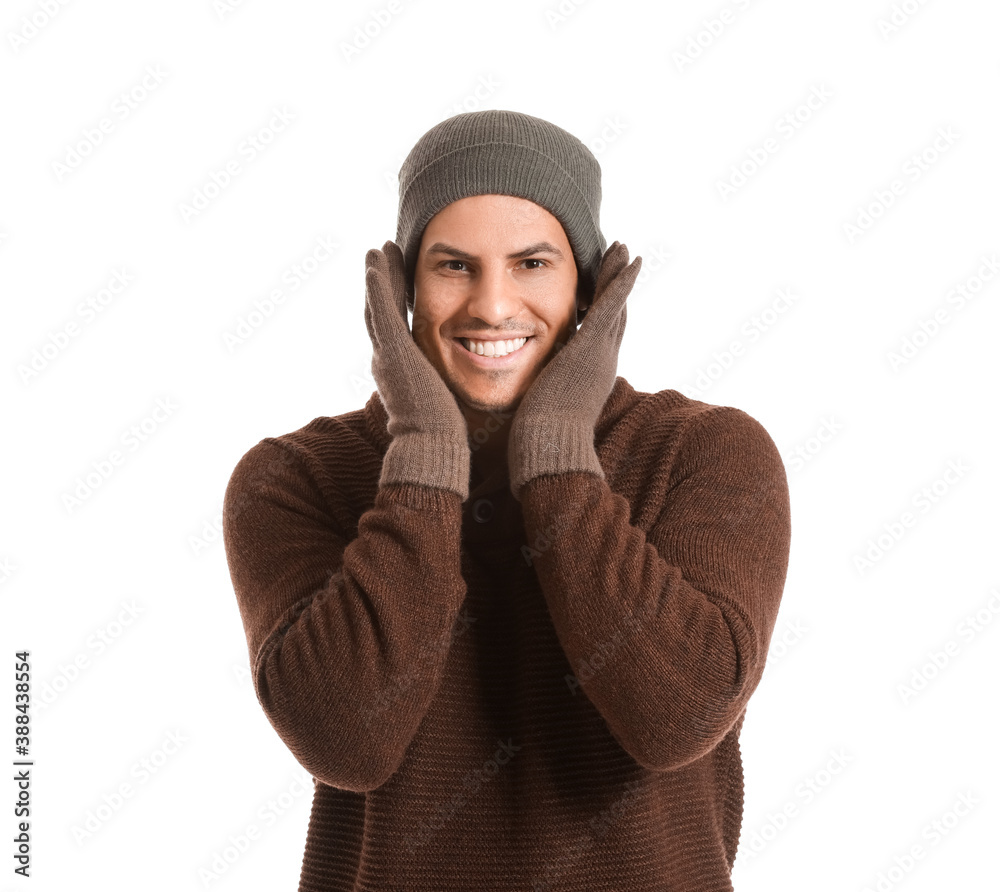 Handsome young man in winter clothes on white background