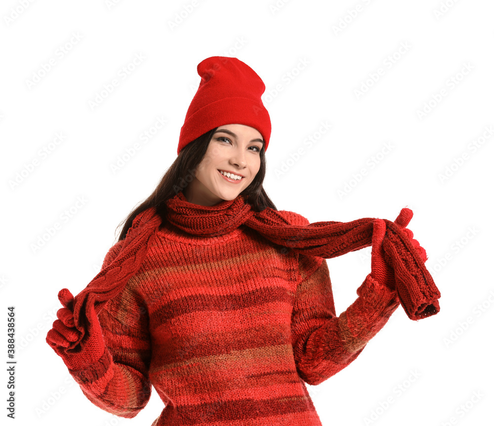 Beautiful young woman in winter clothes on white background