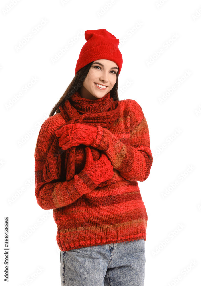 Beautiful young woman in winter clothes on white background