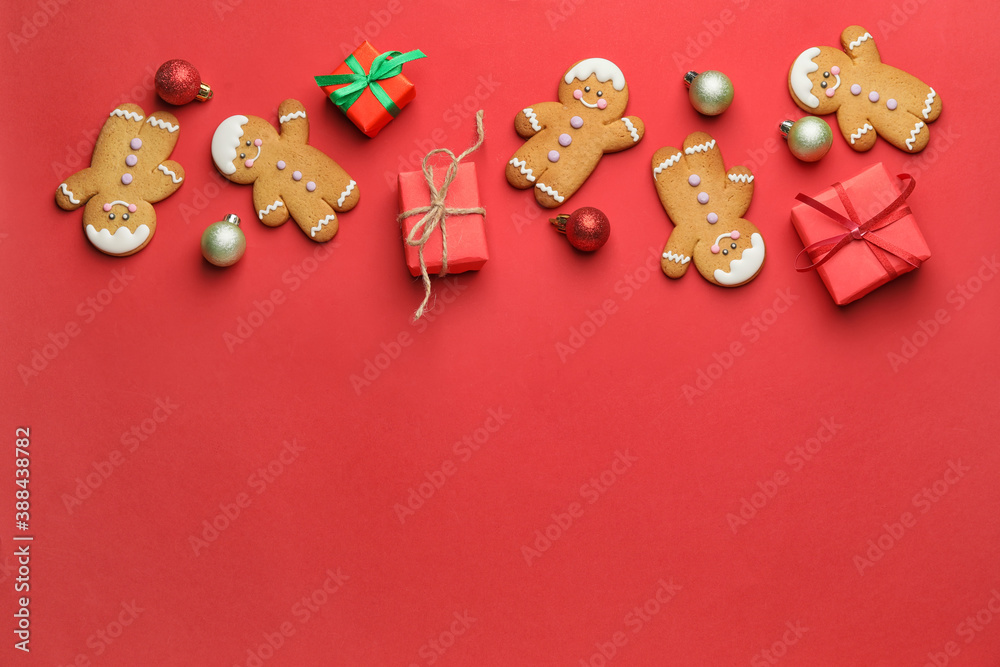 Tasty gingerbread cookies and Christmas decor on color background