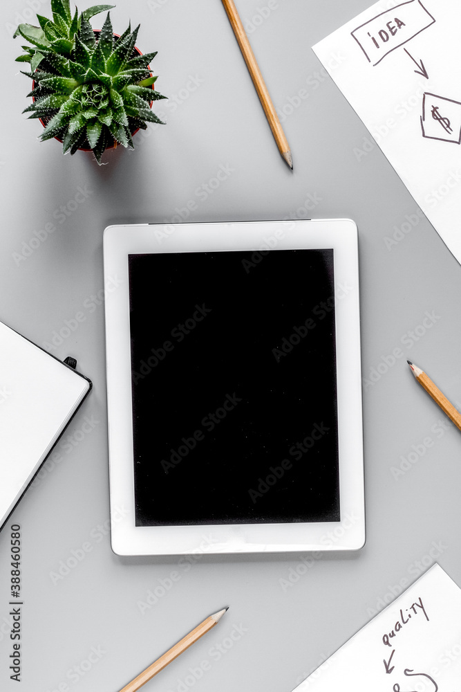 business plan with tablet and chart gray table background top view mock-up