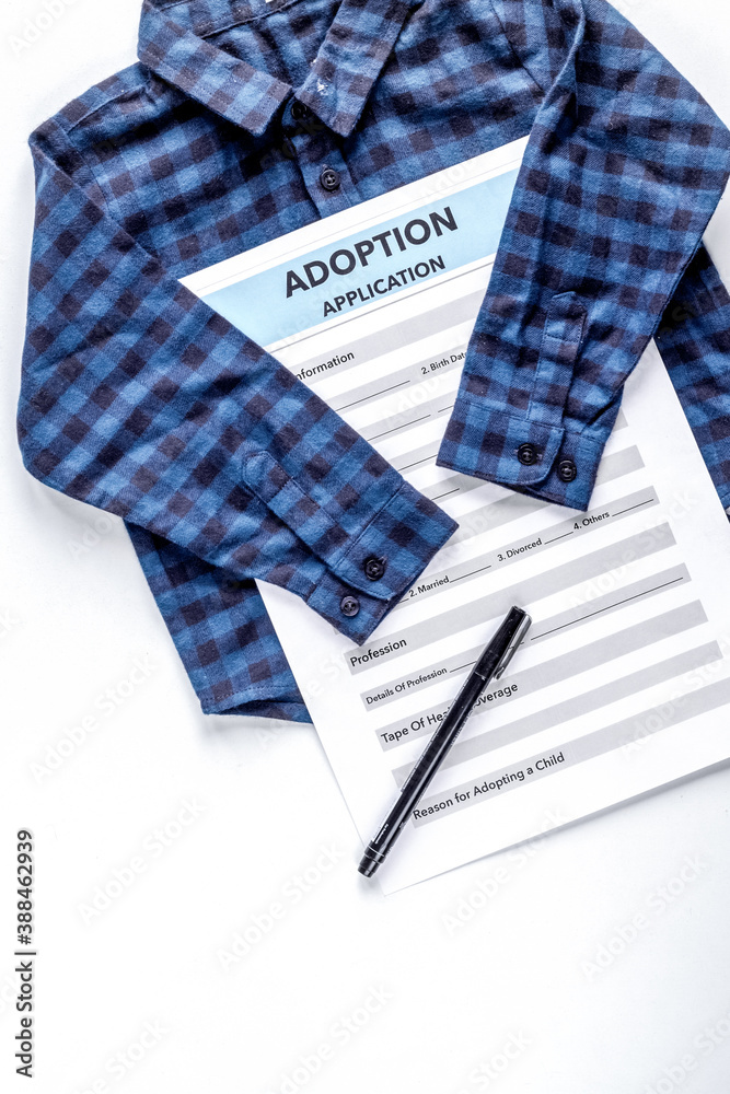 adoption form with clothes in family concept on table top view mock-up