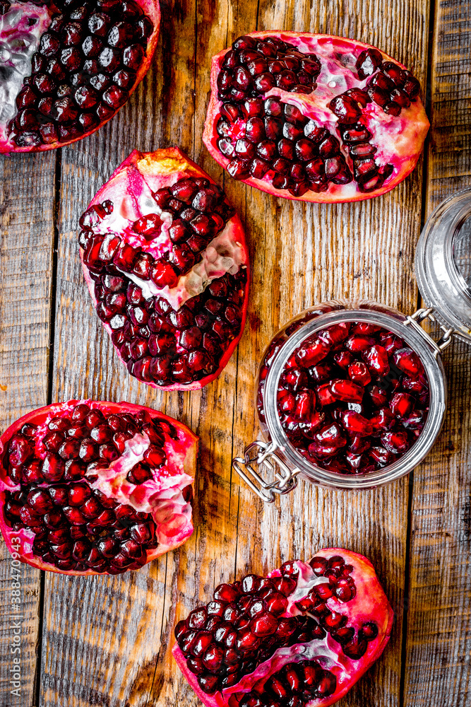 sliced pomegranate on wooden background top view