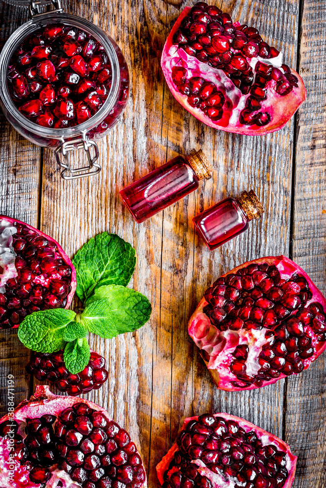 sliced pomegranate on wooden background top view