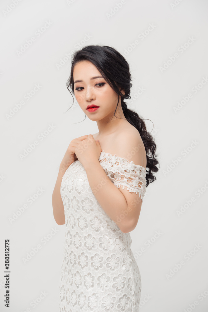 Happy portrait of elegant young Asian woman with white dress. Beauty, fashion concept.