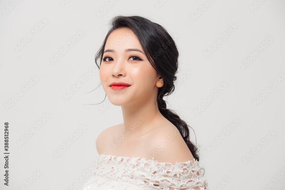 Close up portrait of beautiful young Asian woman isolated over white background. Beauty concept.