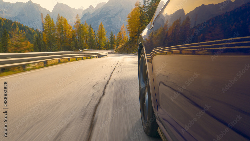 CLOSE UP: Sports car navigates a serpentine route leading through the Dolomites.