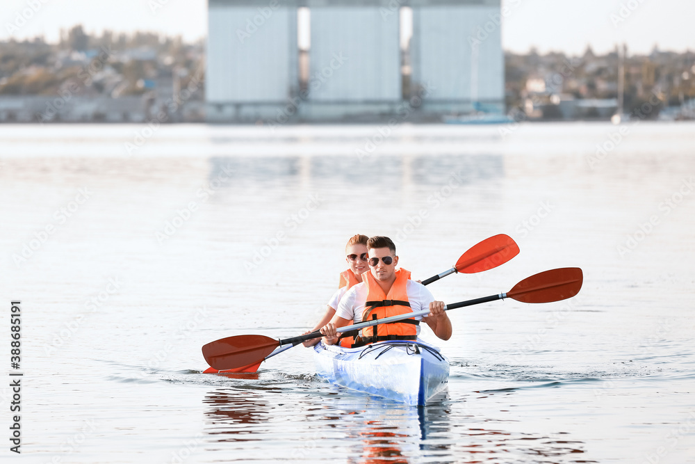 Young couple kayaking in river