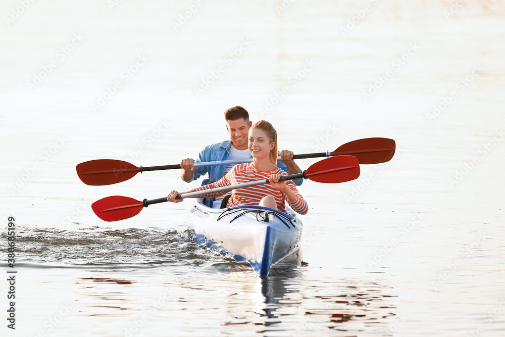 Young couple kayaking in river