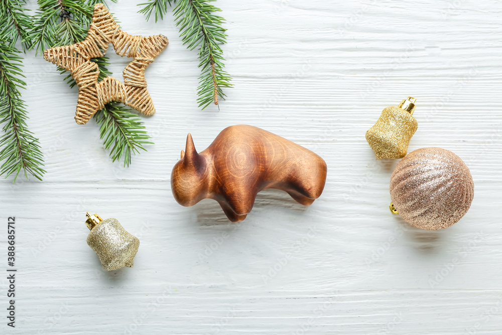 New Year composition with figurine of bull on wooden background