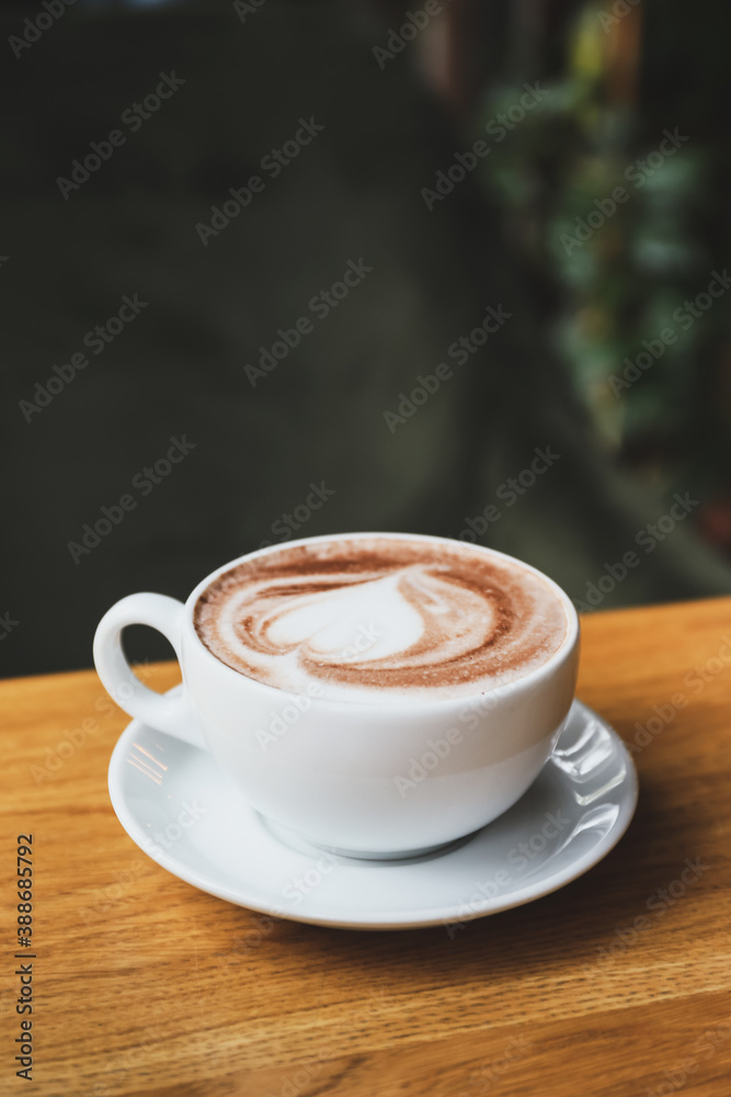 Cup of tasty cappuccino on table in cafe