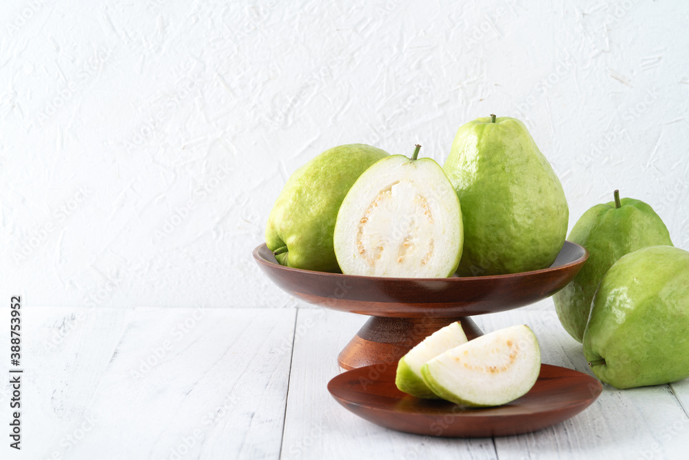 Delicious guava fruit set on white wooden table background with copy space.