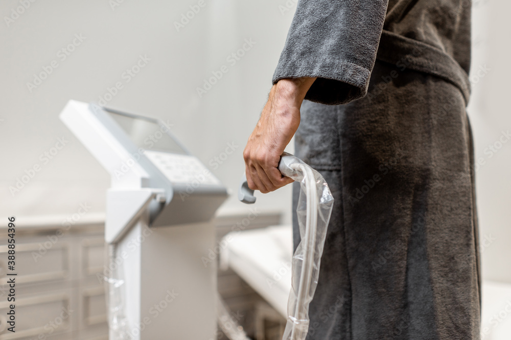 Man measuring body composition balance, holding handles of a medical scales during Inbody test