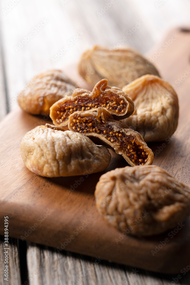 Dried figs on an old wooden background