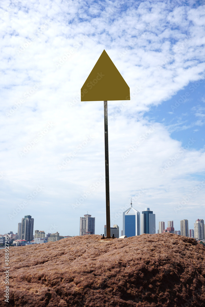 Warning signs on the reef and city coastline background