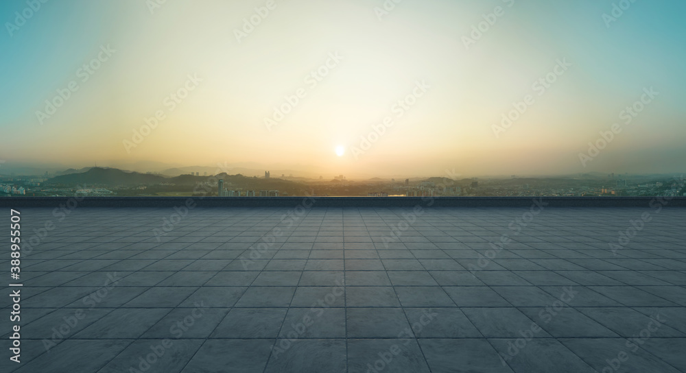 Empty concrete tiles floor with city skyline background