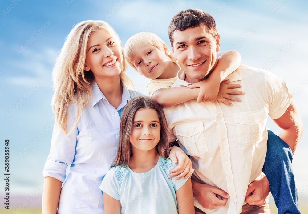 Beautiful smiling lovely family on outdoor background