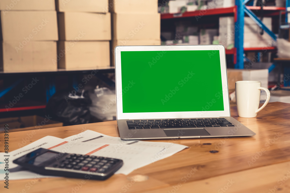 Computer with green screen display in warehouse storage room . Delivery and transportation software 