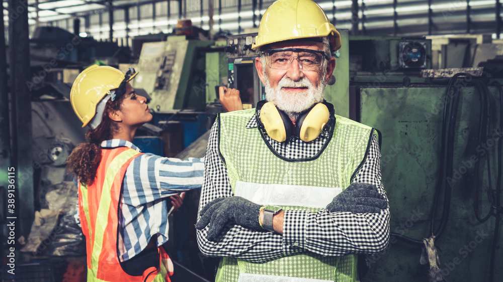 Senior factory worker or engineer close up portrait in factory . Industry and engineering concept .