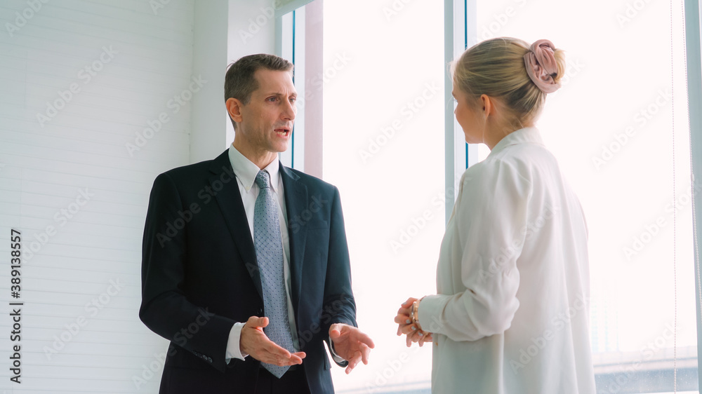 Two business people talk project strategy at office meeting room. Businessman discuss project planni