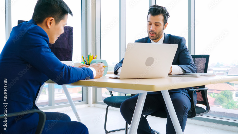 Two business people talk project strategy at office meeting room. Businessman discuss project planni