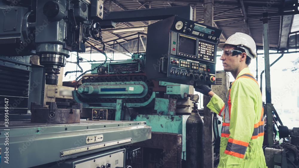 Smart factory worker using machine in factory workshop . Industry and engineering concept.