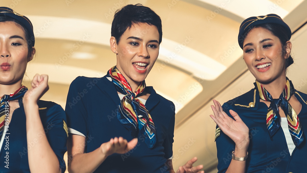 Cabin crew dancing with joy in airplane . Airline transportation and tourism concept.