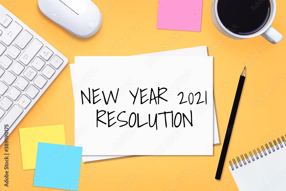 2021 Happy New Year Resolution Goal List - Business office desk with notebook written in handwriting