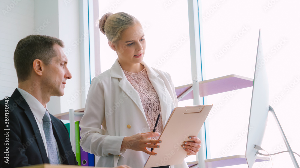 Two business people talk project strategy at office meeting room. Businessman discuss project planni